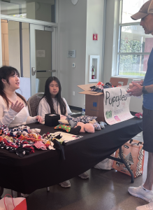 Sophia Liu and a volunteer explain the concept behind Pupcycled during a fundraising event at Oshman Family Jewish Community Center on Sep. 29, 2024. 